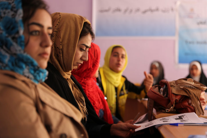 A female Farahi journalist reviews her training guide during photojournalism training at the Directorate of Women's Affairs building in Farah City