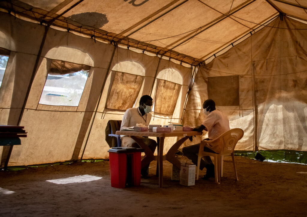 A doctor and a patient in a medical tent in South Sudan.