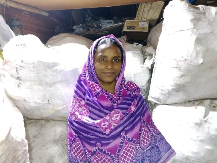 lady standing in front of big plastic bulk bags