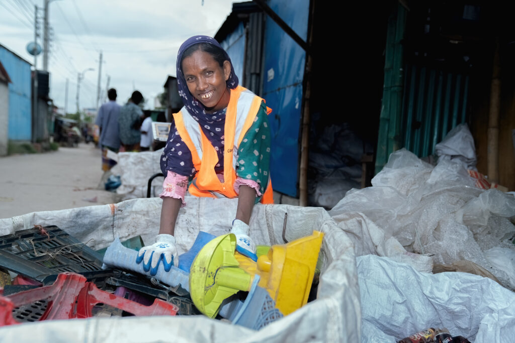 lady in front of big bag full of plastic waste