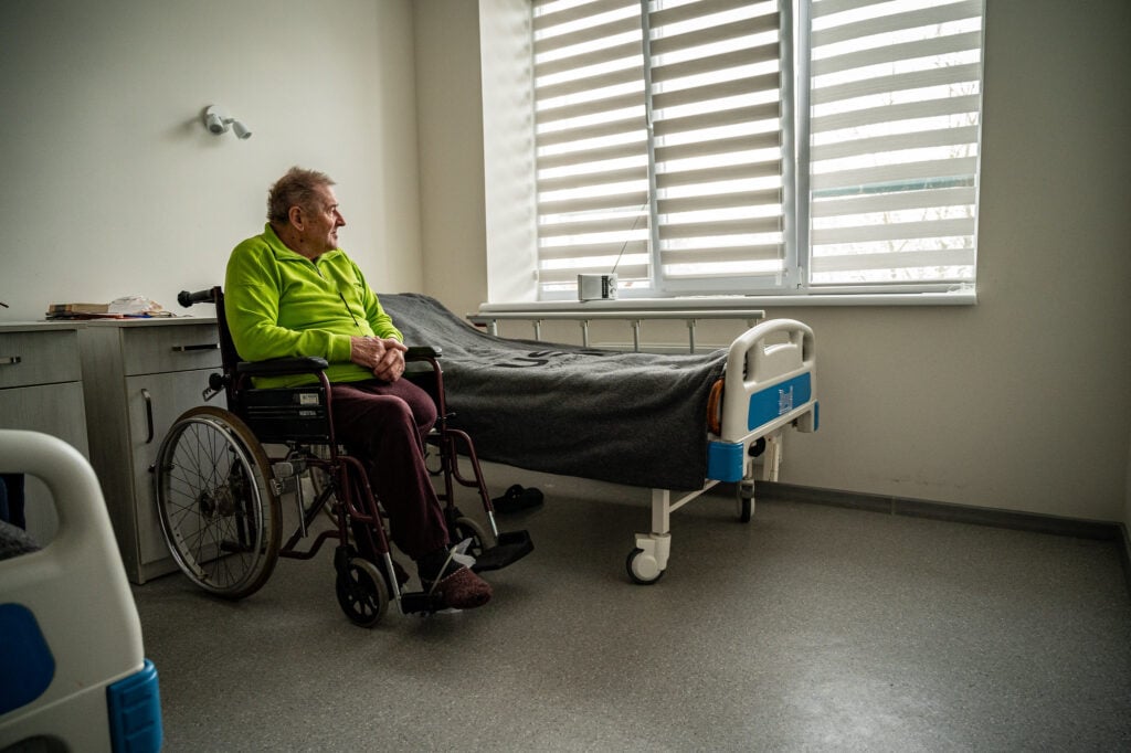 An elderly Ukrainian man in a wheelchair.