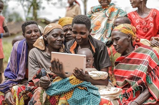 Burundians looking at a tablet.