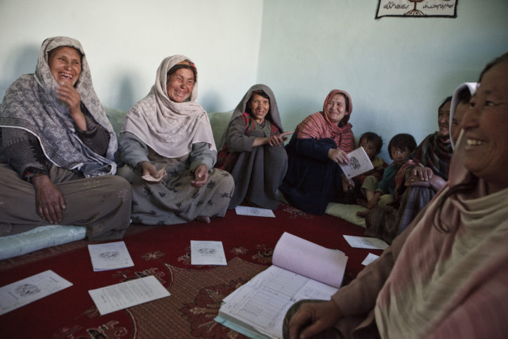 Afghan women sit in circle laughing