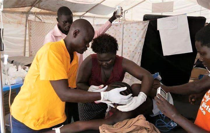 woman during delivery assisted by health care workers