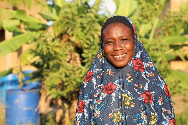 Young woman smiling standing outside