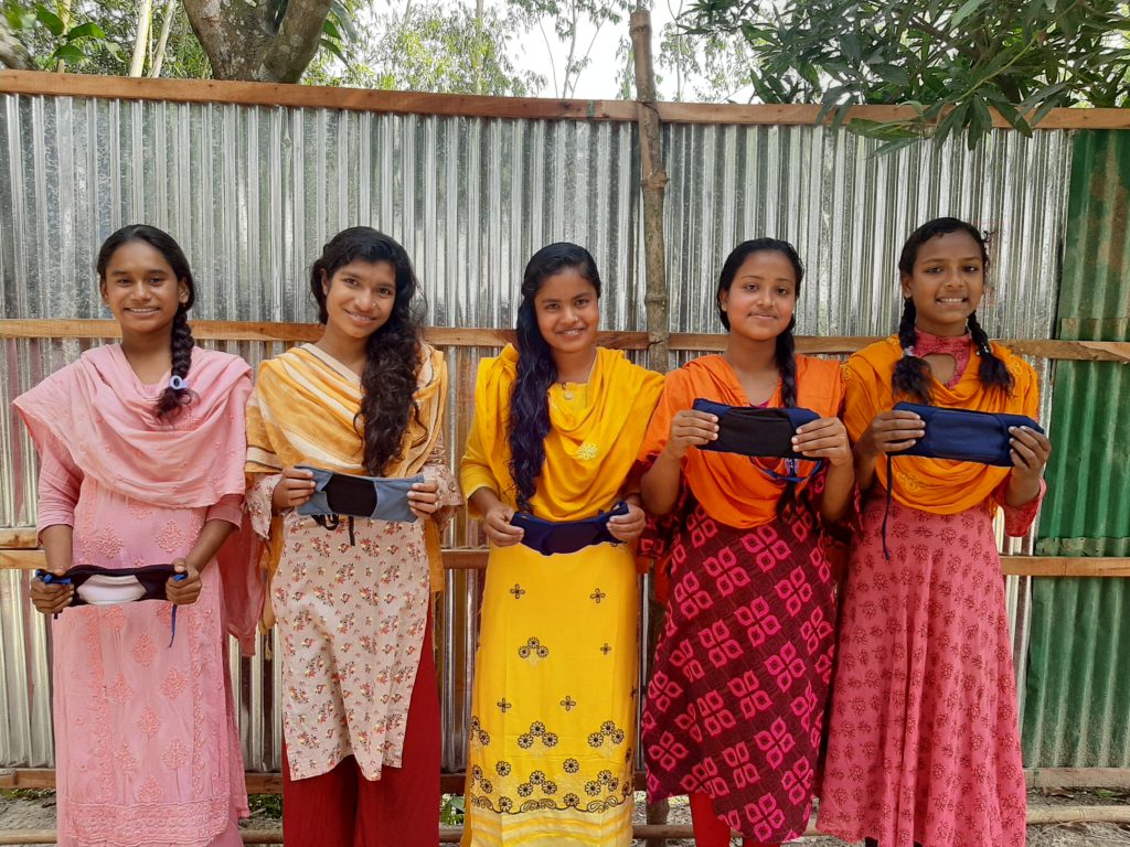 five young women showing and promoting the ELLA pad, which stands for eco-friendly low-cost liquid absorbent sanitary pad